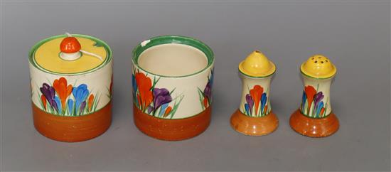 A Clarice Cliff salt, pepper and two mustard pots (one lacking cover)